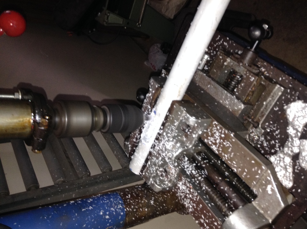 PVC tube in vice of running drill press.