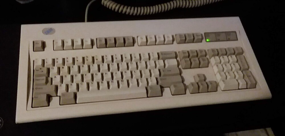 Cleaned, full-size IBM Model M from 1994 on black desk