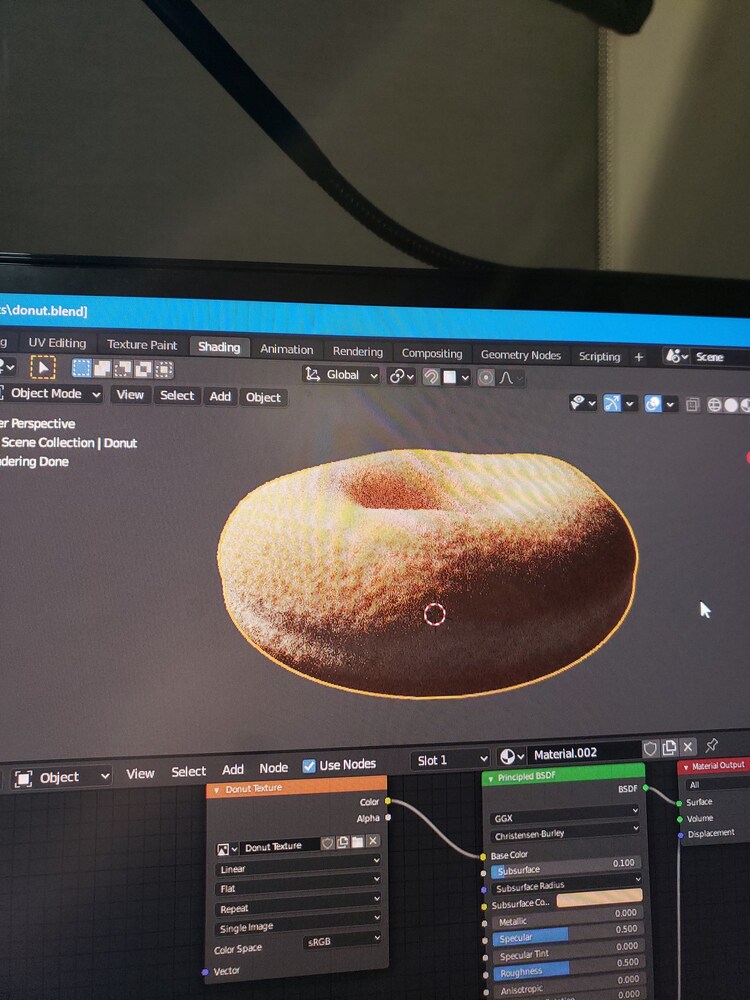 Donut with more refined texture. Node editor visible on bottom third of shot.