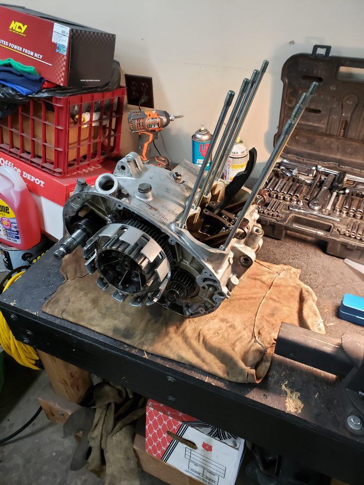 1981 XS650 lower half of engine with pistons removed sitting on workbench.