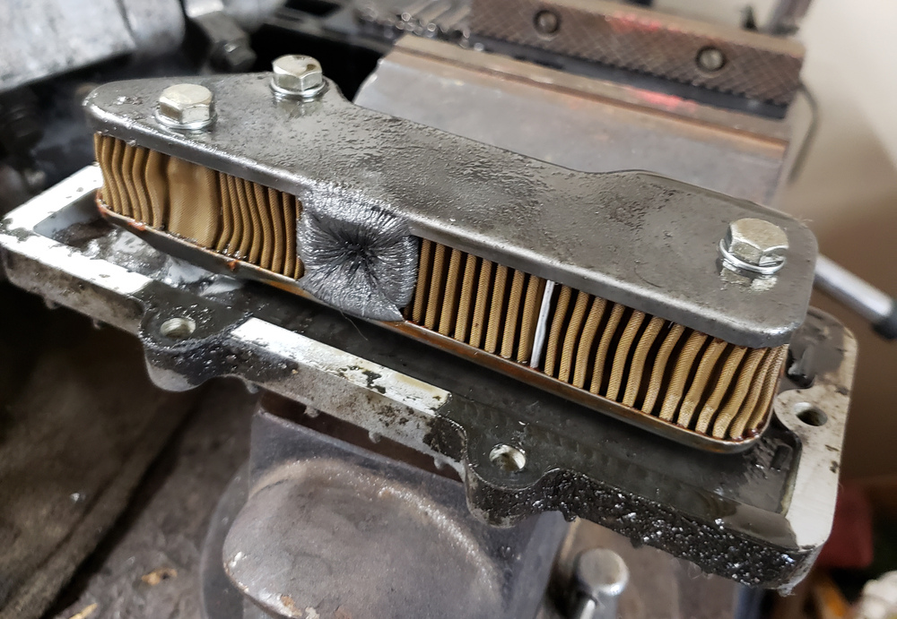 1981 XS650 oil filter, opposite side, with buildup of metal shavings on magnet.