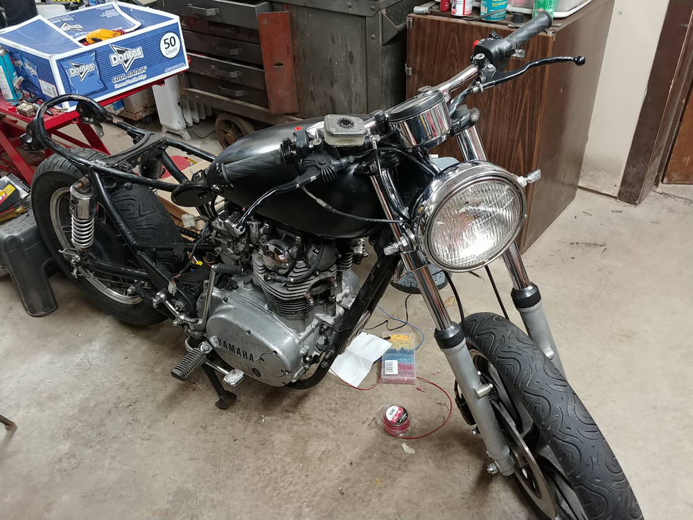 Front view of a stripped down 1981 XS650 in a workshop.